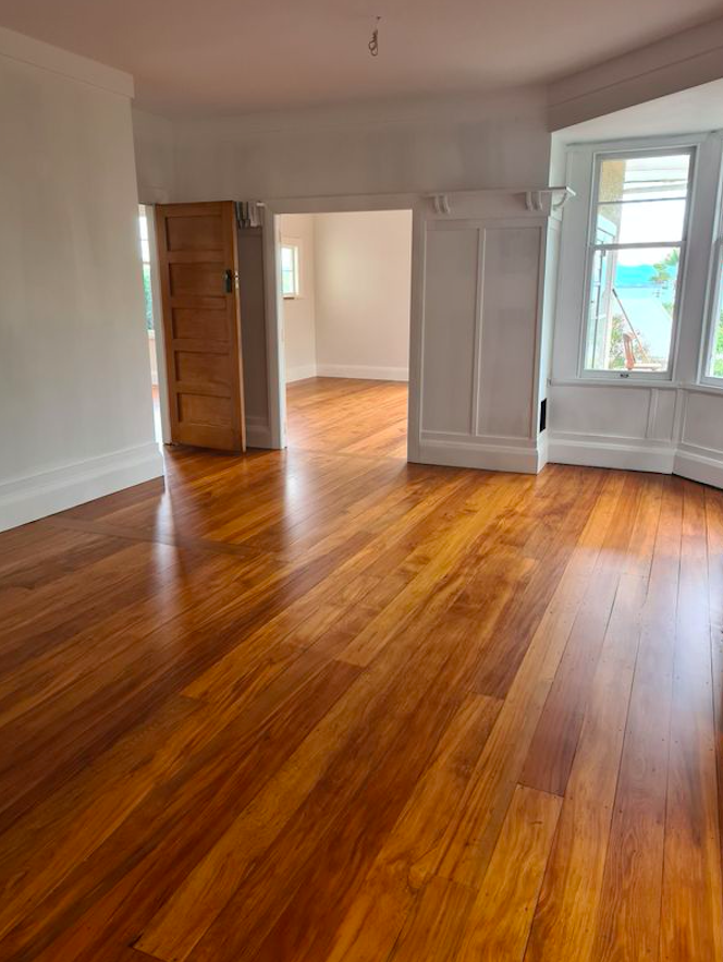 Large open room with hard-wearing moisture-cured polyurethane on a restored hardwood floor