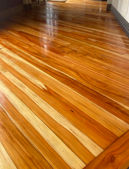 Wooden floor restoration in Auckland with rich refinished timber boards