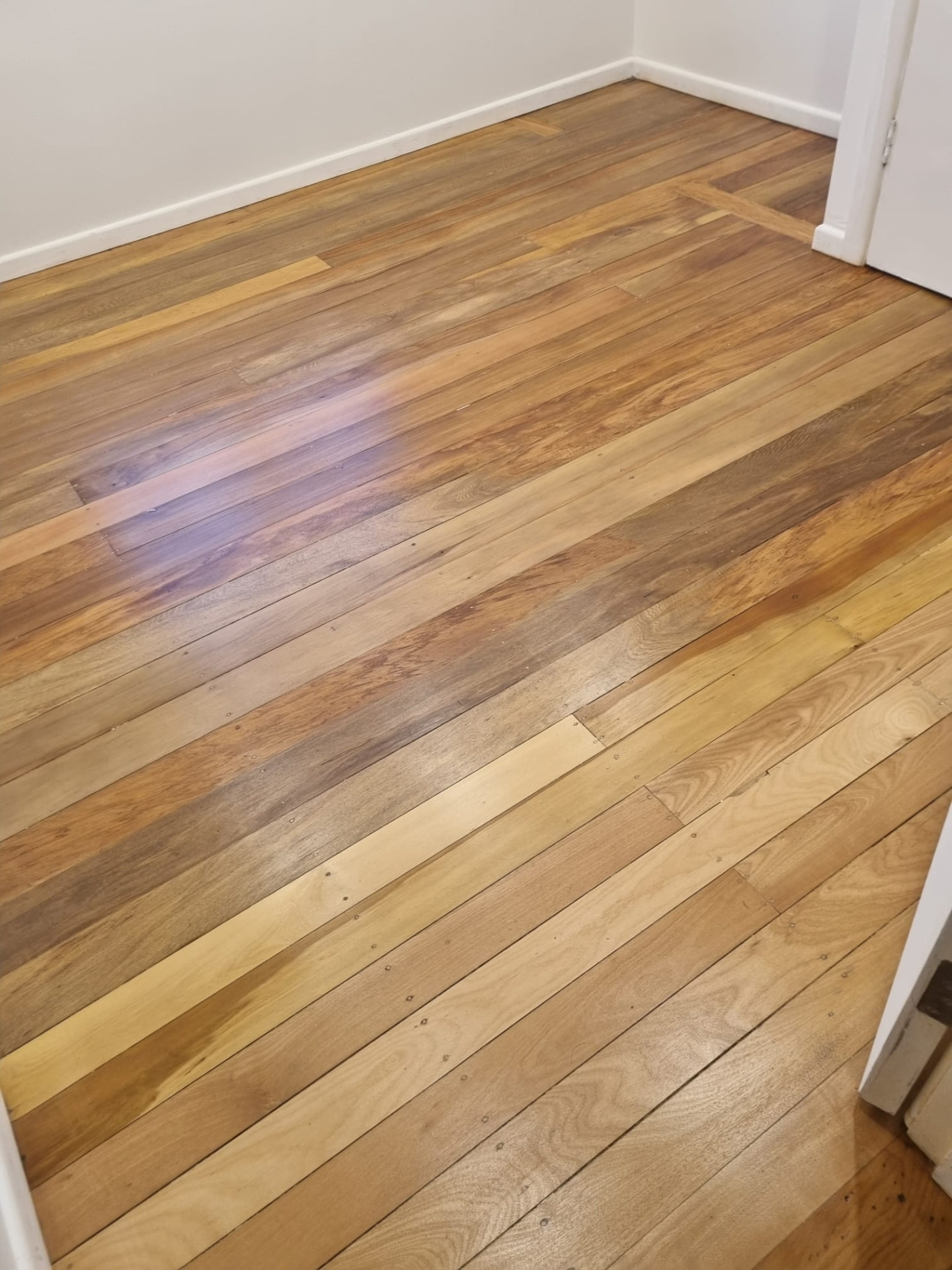 Warm sanded and polished timber floorboards in an Auckland home